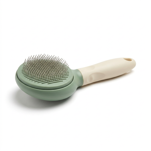 Sage green and cream pet grooming brush on a white background